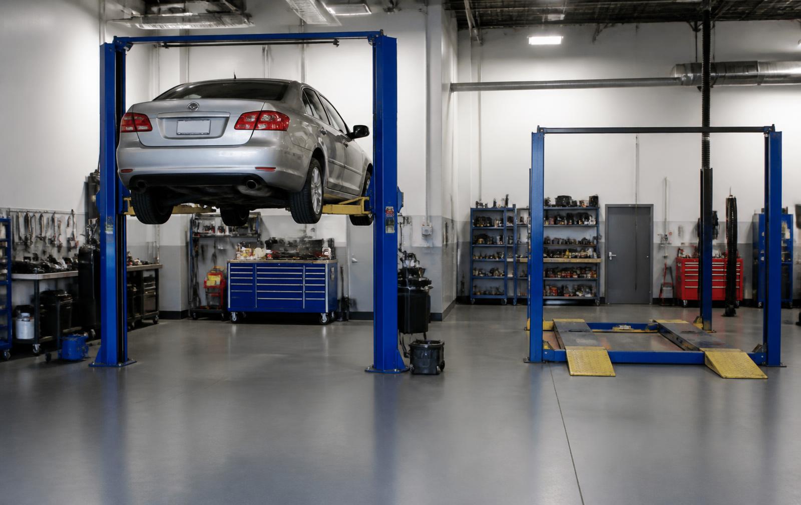Service bays at C & A Auto Repair in West Chicago, IL with a car raised on the hydraulic lift